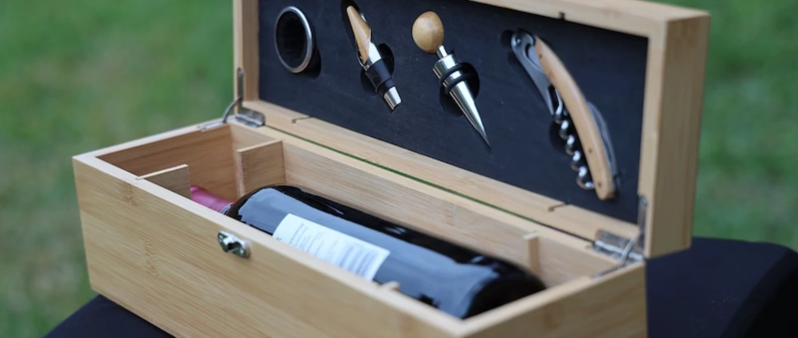 Personalized bamboo wine gift box open, showing the corkscrew, stopper, pourer and ring inside the lid