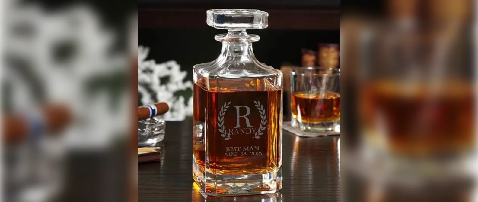 Personalized engraved whiskey decanter with a monogram, on a dark bar