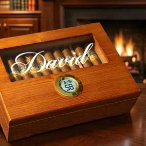 Custom cigar humidor in cedar engraved with the name David, filled with cigars, by a fireplace